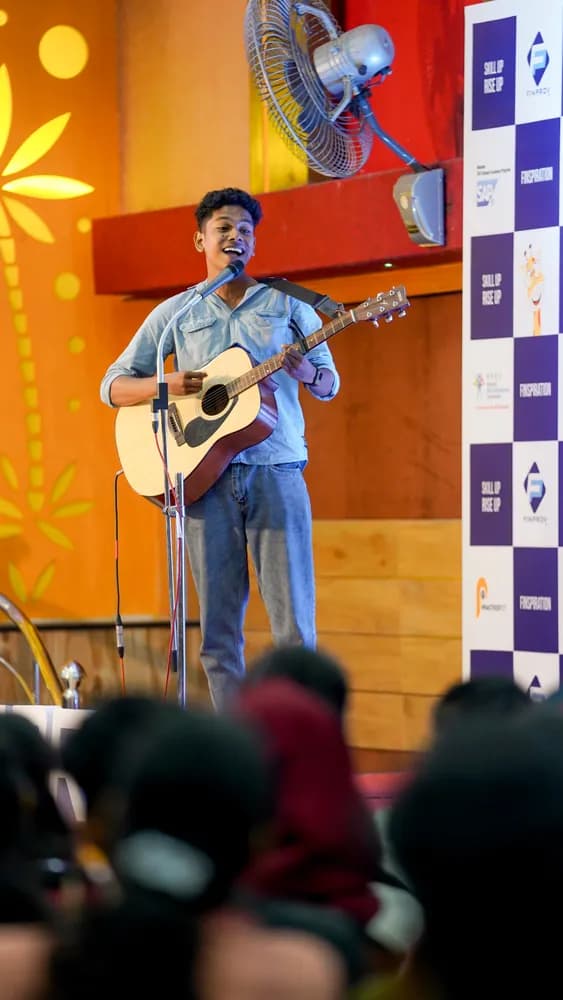 Student performing music on stage at Finspiration