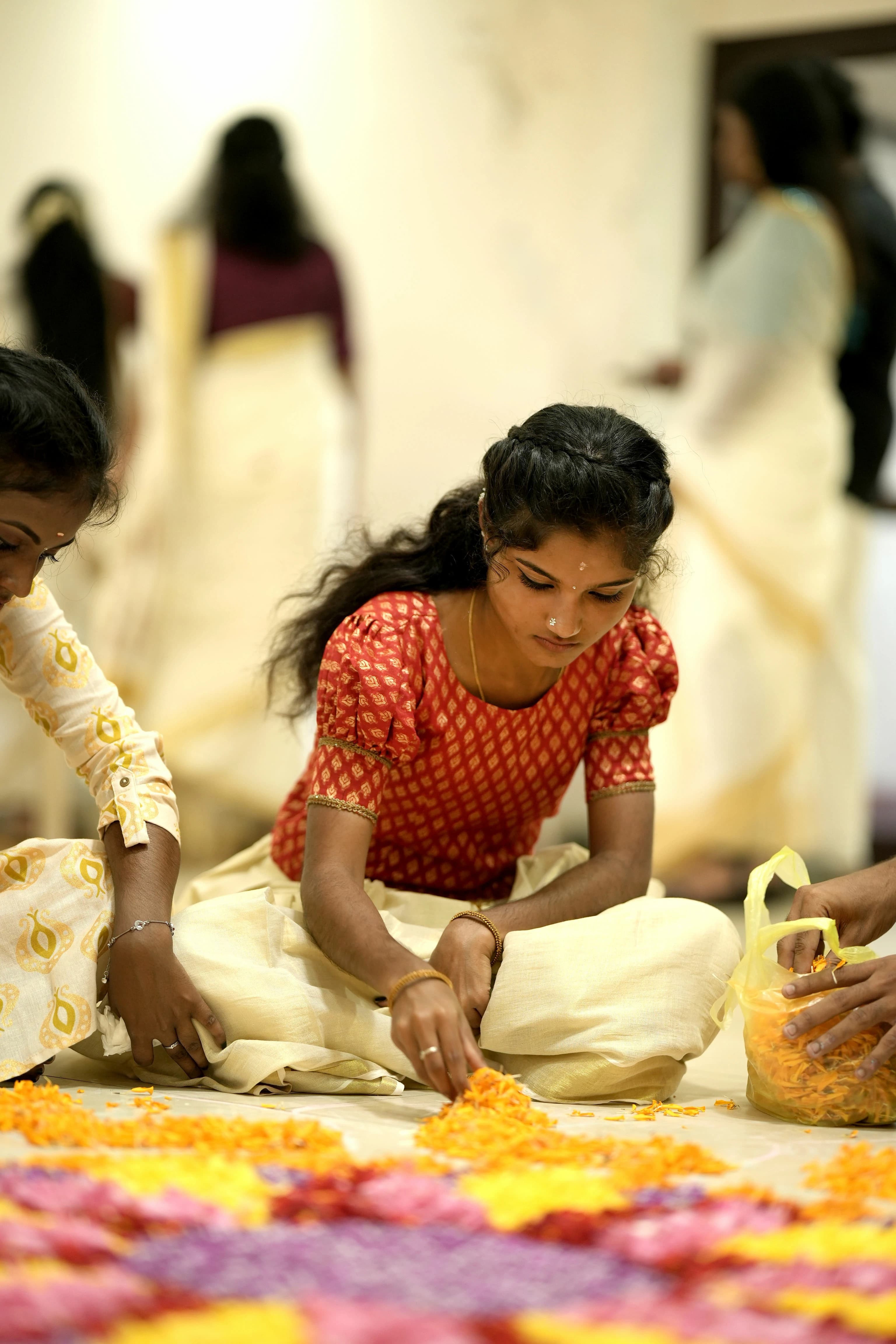 A learner arranging a pookkalam for Onam at Finprov